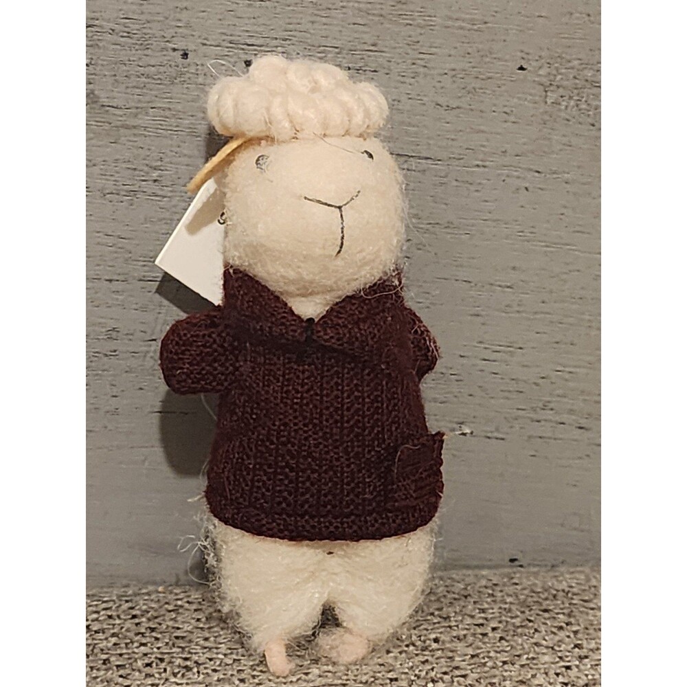 Wool felted sheep with rose behind back
